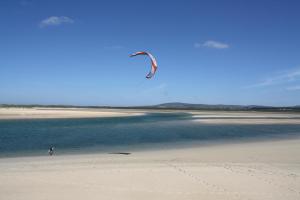 a person is flying a kite on the beach at Mulranny Park Hotel in Mulranny