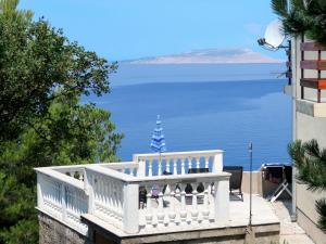 a white balcony with a view of the water at Holiday Home Mara - KBG400 by Interhome in Matijević
