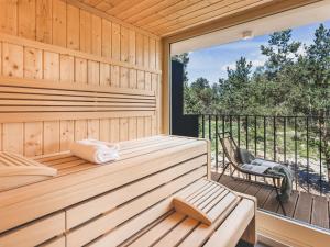 een sauna met een bank en een stoel op een terras bij Apartment Mariandl am Meer-5 by Interhome in Staphel