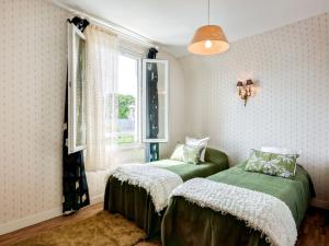 a bedroom with two beds and a window at Holiday Home Rayon de soleil by Interhome in Carnac