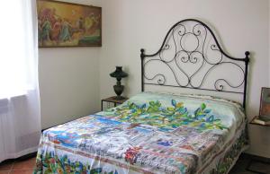 a bedroom with a bed with a colorful quilt at Casa con vista fantastica in Perugia