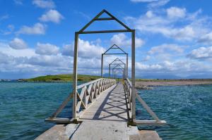 a wooden pier in the water on a beach at Mulranny Park Hotel in Mulranny
