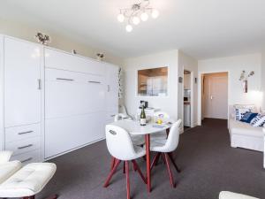 a kitchen and living room with a table and chairs at Apartment Les Trois Iles-9 by Interhome in Quiberon +14 photos