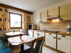 a small kitchen with a table and a table and a window at Apartment Apart Maashof II by Interhome in Galtür