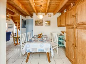 a dining room with a table and chairs at Holiday Home Ker Kébec by Interhome in Crozon