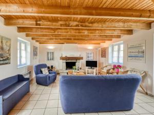 a living room with blue couches and a fireplace at Holiday Home Ker Kébec by Interhome in Crozon +16 photos