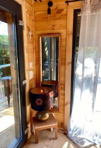 a wooden room with a large mirror and a vase at La mahasiah in Puget-sur Argens