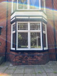 a window on the side of a brick building at Stylish Apartment With Secure Parking Close to City in Chester