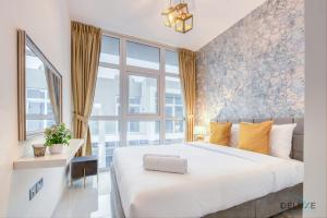 a bedroom with a large bed and a large window at Opulent 3BR Townhouse at DAMAC Hills 2 Dubailand by Deluxe Holiday Homes in Dubai +41 photos