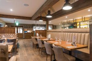 a dining room with wooden tables and chairs at Forest in Burnley