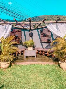 a house with a patio with plants in it at Pousada Casa Recanto da Serra in Petrópolis