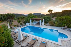 a swimming pool with chairs and a gazebo at Villa in Ibiza Town, sleeps 11 - Can Monte in San Jose