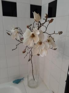 a vase filled with white flowers on a table at City terrace-apartment in Vienna +14 photos