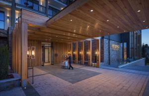 a person walking through a lobby of a building at Viceroy Kopaonik Serbia in Kopaonik