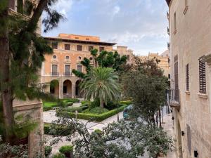 a view of a building with trees and a courtyard at Vila Damunt in Palma de Mallorca