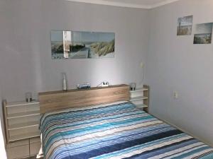 a bedroom with a bed and a mirror on the wall at An der Allee 7 App in Dahme