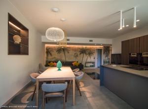 a kitchen and living room with a table and chairs at Dbhousetaormina in Taormina