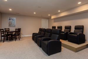 a waiting room with black chairs and a table at Luxurious House with Pool Near Asheville by Mighty Tree Properties in Leicester +23 photos