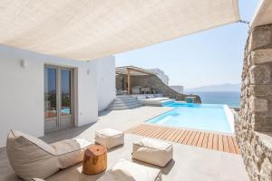 a villa with a swimming pool and the ocean at Bellevue Villas in Plaka