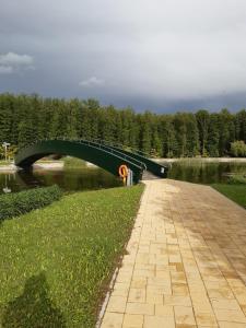 a bridge over a body of water with trees at SpaRelax Apartman Zalakaros in Zalakaros