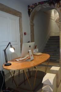 a desk with a lamp and a wooden table at Esqina Urban Lodge in Lisbon