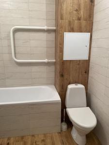 a bathroom with a toilet and a tub and a sink at PaulMarie Apartments on Kozlova, 1A/2 in Salihorsk