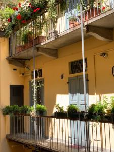 a building with potted plants on its balconies at Fifty Eight Suite Milan Brera in Milan