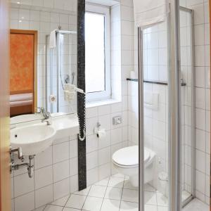 ein Bad mit einem WC und einem Waschbecken in der Unterkunft Hotel Graf Lehndorff zur Messe in München