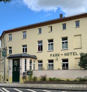 a large tan building with a park hotel at Parkhotel Schnorr in Lutherstadt Eisleben