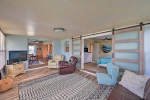 a living room with a bed and a tv at Waterfront Lake Placid Escape with Dock and Lanai in Lake Placid