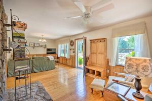 a living room with a couch and a ceiling fan at Charming Cottage Less Than 10 Mi to Wineries and Skiing! in Nellysford