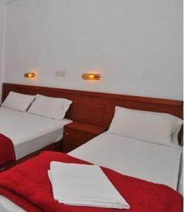 two beds sitting next to each other in a room at Chrissafis Hotel in Panagia