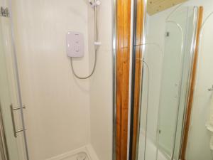 a shower in a bathroom with a glass shower stall at Glyder Fach in Bangor