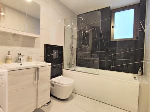 a bathroom with a toilet and a tub and a sink at Villa Pavlina in Ixia +7 photos