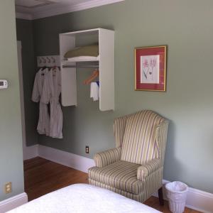 a room with a chair and a towel rack at Sinclair Inn Bed & Breakfast in Jericho