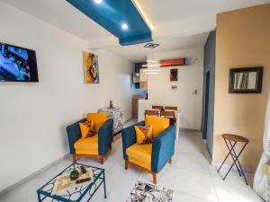 uma sala de estar com duas cadeiras e uma mesa em MOOKSQUARE GJ SPOT em Douala