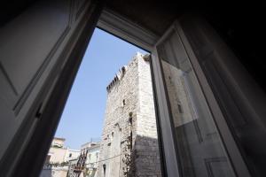 a window view of a tall brick building at Domus Castrum in Bisceglie