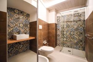 a bathroom with a shower and a toilet at Domus Castrum in Bisceglie
