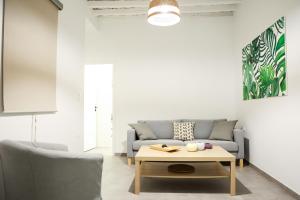 a living room with a couch and a coffee table at PS House Kimolos - Ps Rental in Kimolos