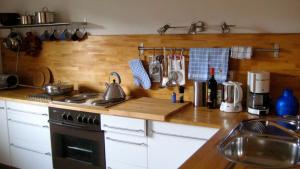 a kitchen counter with a stove and a sink at Ferienwohnung Ebner in Kiefersfelden