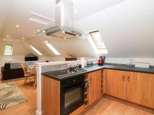 a kitchen with a sink and a stove at Hayloft in Peterhead