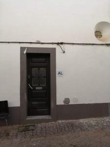 a door on the side of a building at Casa das Histórias in Beja