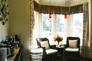 a living room with two chairs and a window at The Whitetail Inn and Suites- Lincoln in Lincoln