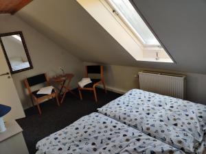En eller flere senge i et værelse på Købmandsgaardens B&B