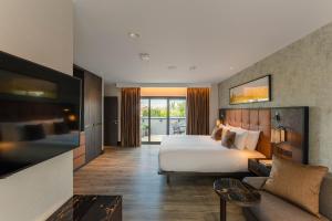 a hotel room with a bed and a couch at The Fellows House Mews in Cambridge