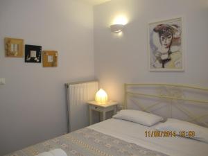 a bedroom with a bed and a picture on the wall at Muses Studios Sami in Sami