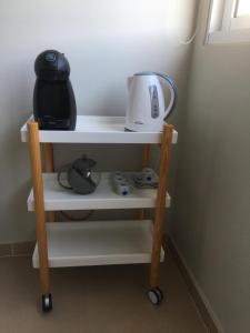 a shelf with a tea kettle on top of it at Cantinho do Sonho in Maia