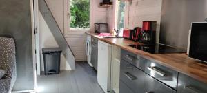 a small kitchen with a counter and a sink at Le Chalet de la Villa Terre Neuve in Signes