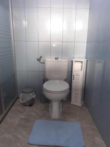 a small bathroom with a toilet and a rug at Cantinho do Sonho in Maia