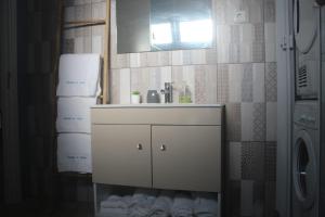a bathroom with a white sink and a mirror at Cantinho do Sonho in Maia